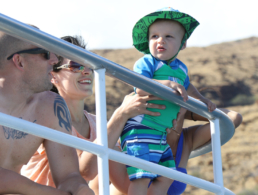 Young baby with looking at the ocean in amazement.