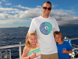 Father with son and daughter on a snorkel cruise.
