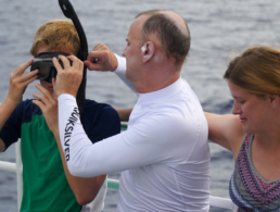 Man helping son with snorkel mask