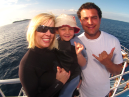 Mother and father with their toddler on the Pride of Maui boat.
